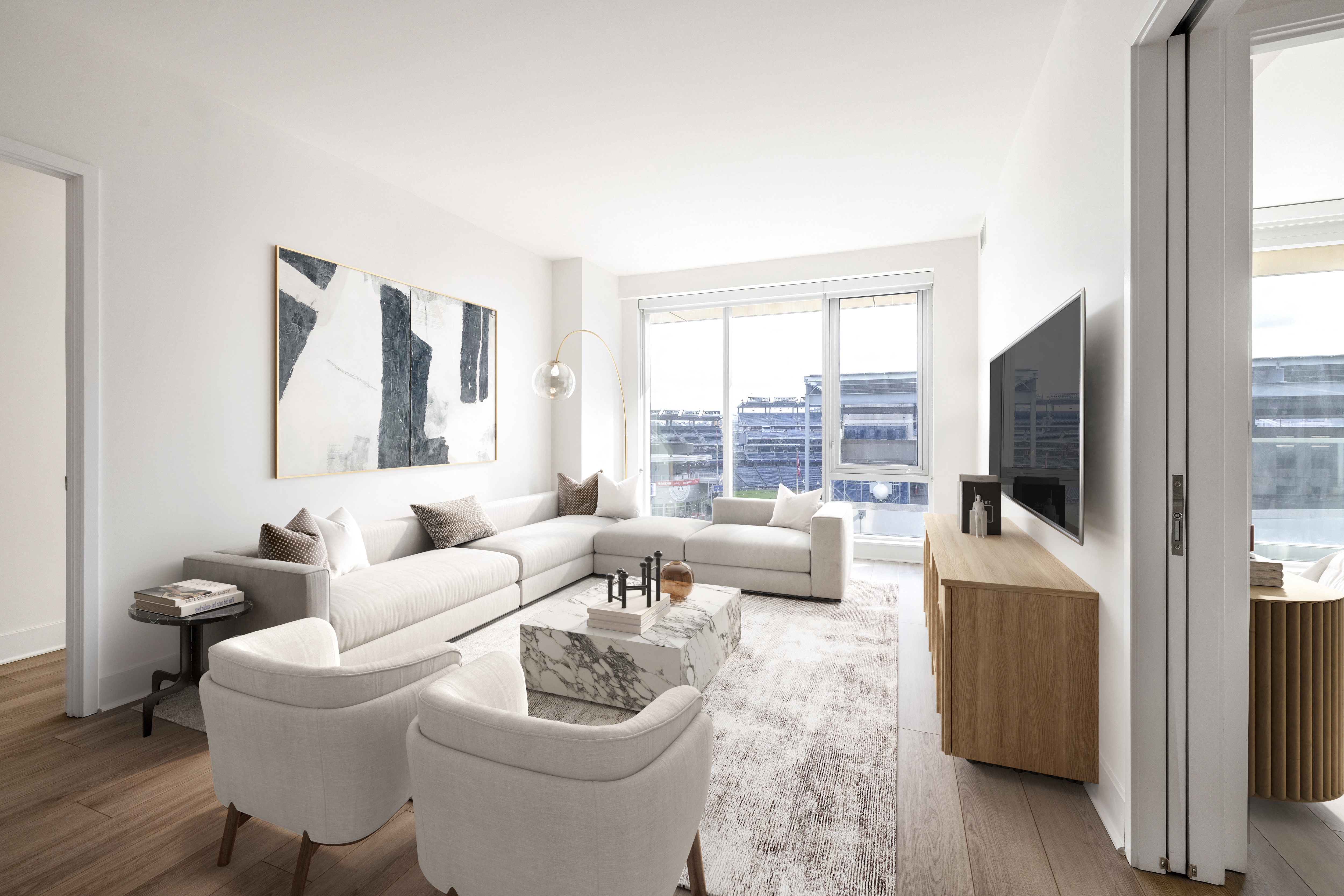 a living room with white furniture and a large window